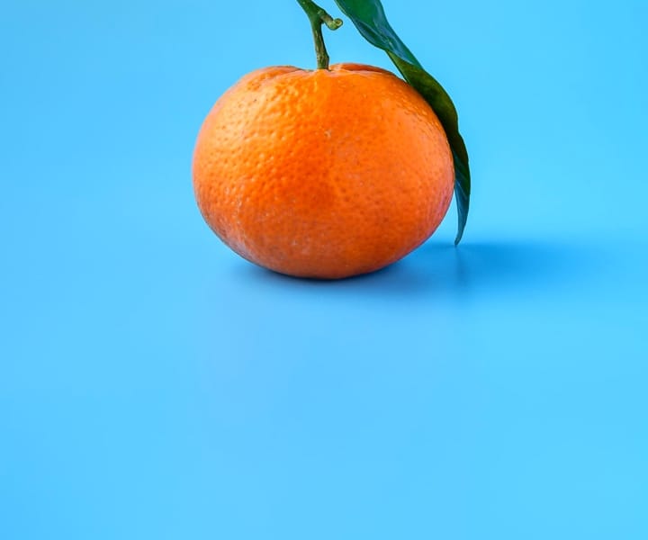 Tangerine on blue background